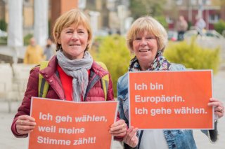 Zwei Frauen mit Schildern